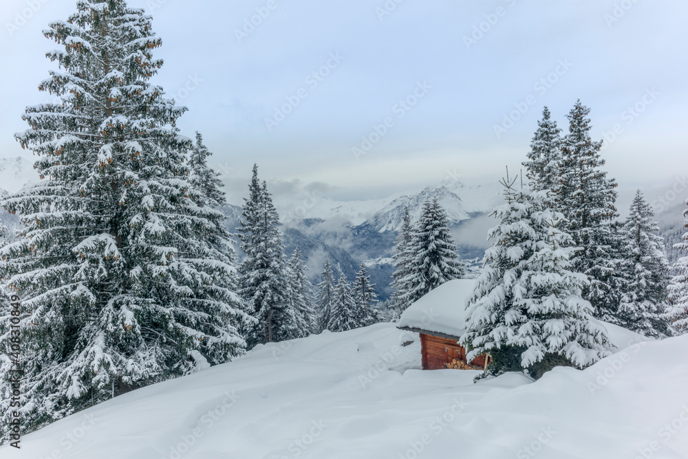 Isolated summer chalet and villages high up on the Swiss Alps covered in fresh powder snow near Davos