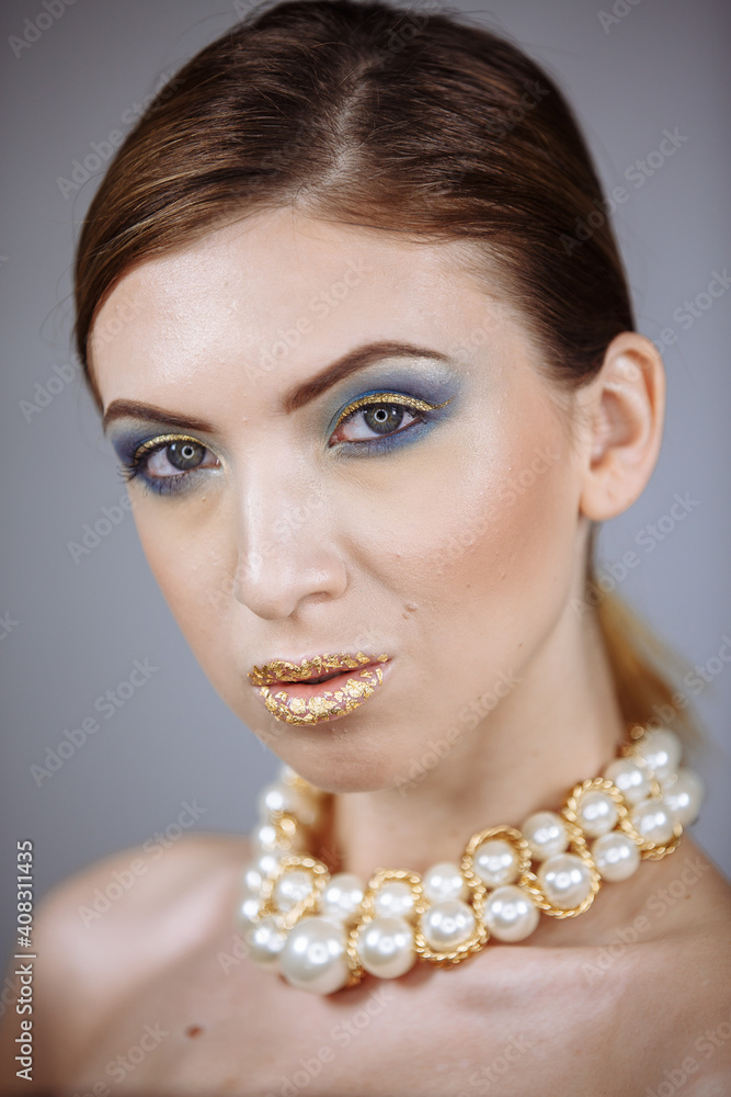 portrait of a girl with large white beads on a white background