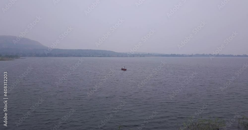 Seascape With Boat Sailing At Trimbakeshwar, Western Ghats Of Maharashtra, Nashik, India. - Aerial Wide Shot Seascape With Boat Sailing At Trimbakeshwar, Western Ghats Of Maharashtra, Nashik, India. - Aerial Wide Shot