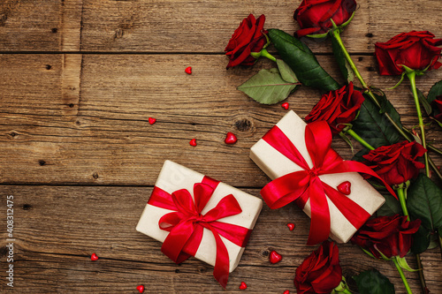 Fototapeta Naklejka Na Ścianę i Meble -  Valentine greeting card background with gift boxes, fresh burgundy roses and assorted hearts