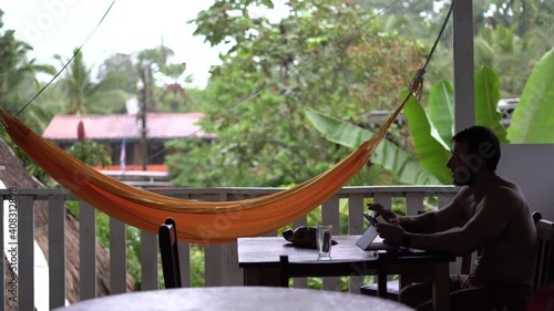 Digital nomad man working on a videoconference with tablet from the country of Costa Rica photo