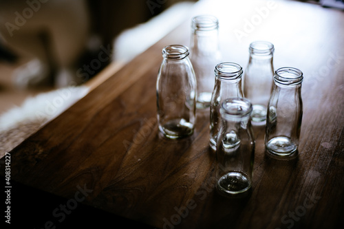 selective focus of empty glass bottle on wooden table
