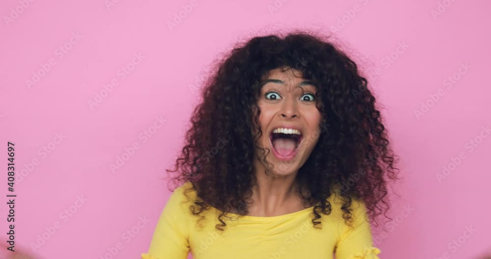 amazed young woman celebrating triumph isolated on pink amazed young woman celebrating triumph isolated on pink
