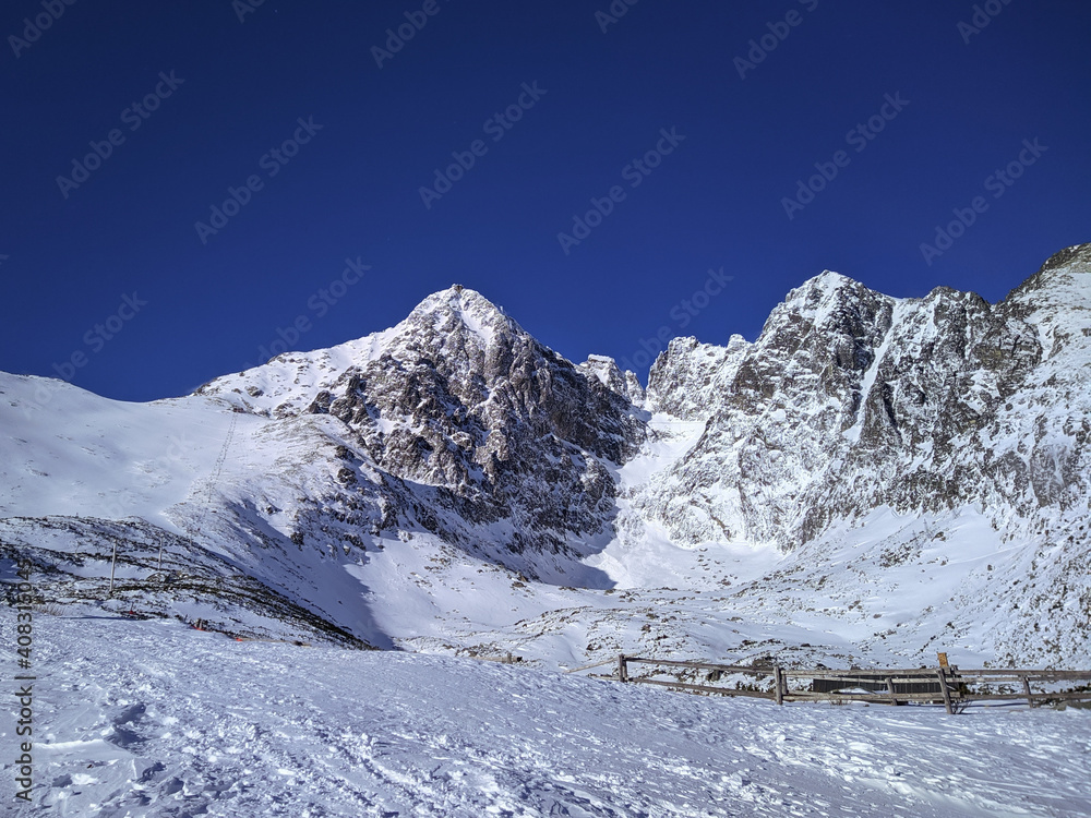 Snow covered mountain range against clear blue sky . Active winter holidays in High Tatras, Slovakia 