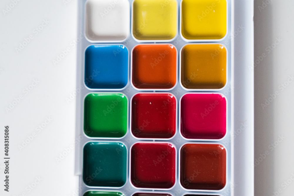 Top view of set of watercolor paints  in a box, isolated on white.