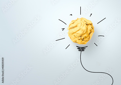 Yellow scrap paper ball with illustration painting for virtual lightbulb. It is creative thinking idea and innovation concept. photo