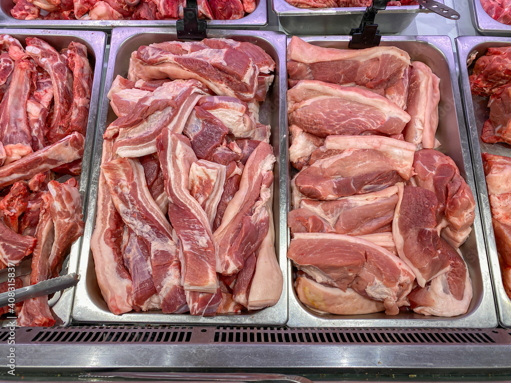 Raw pork meat for sale at butcher stall in supermarket