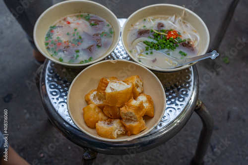 Photography Bowls of delicious Vietnamese pig organs and bloodcake porridge