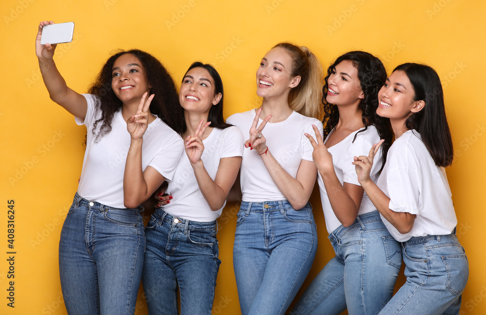 Group Of Women Making Selfie On Mobile Phone, Yellow Background Group Of Women Making Selfie On Mobile Phone, Yellow Background