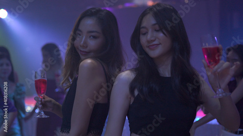 Schilderij op canvas Group of asian dancing friends enjoying night party