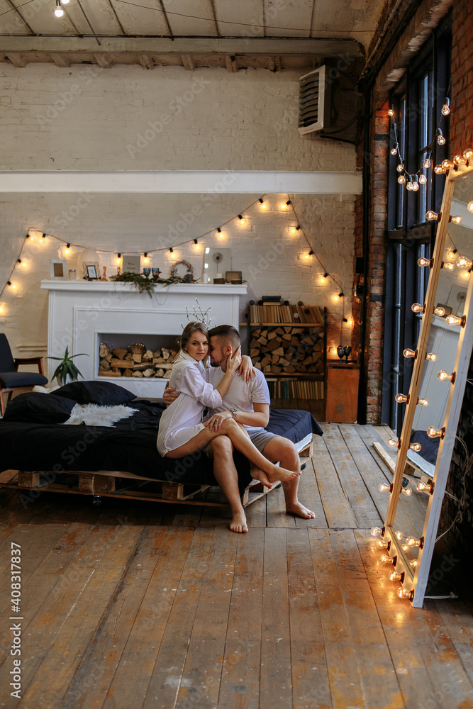 couple hugging in bed with lights