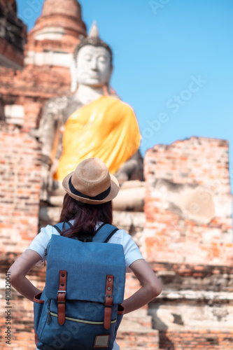 Asian woman tourists carrying a backpack and wearing a hat Visit Wat Yai Chaimongkol, the historical archaeological site of Phra Nakhon, Ayutthaya. © Small fish