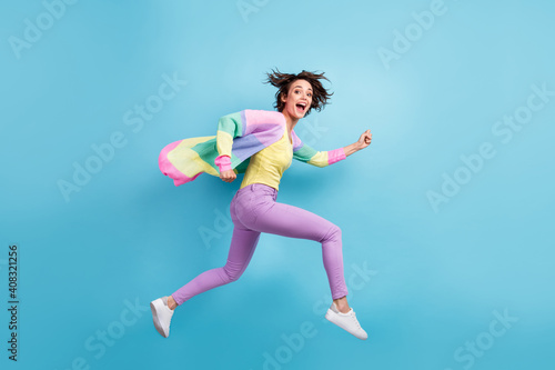 Fototapeta Naklejka Na Ścianę i Meble -  Photo portrait full body side view of screaming running girl isolated on pastel blue colored background