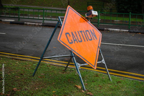 Photography Caution sign at the roadside on a rainy day