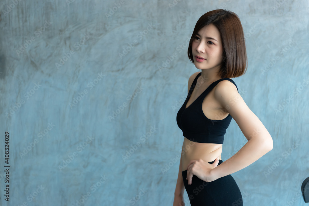Fototapeta premium Close up asian beautiful sport girl on wall of gym,Thailand love health,Slim woman workout concept