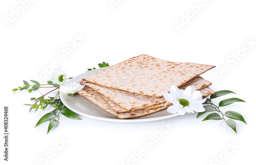 Jewish flatbread matza for Passover and flowers on white background photo