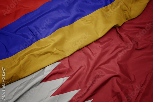 waving colorful flag of bahrain and national flag of armenia.