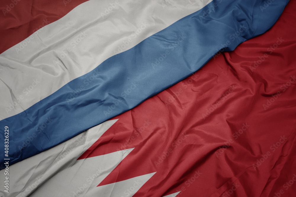 waving colorful flag of bahrain and national flag of luxembourg.