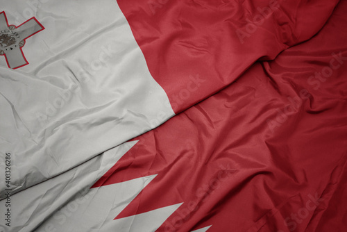 waving colorful flag of bahrain and national flag of malta.