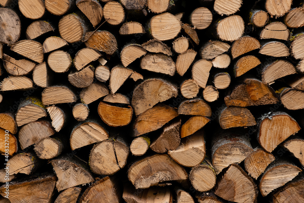 foreground of a pile of split firewood with ends of firewood of different shapes foreground of a pile of split firewood with ends of firewood of different shapes