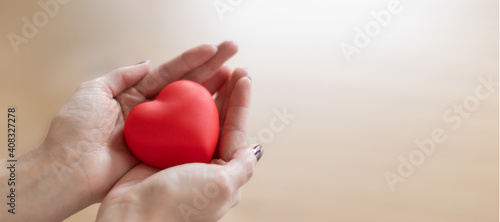 A woman holding a red heart between her hands. Happy valentine   s day  red color  heart icon  isolated background