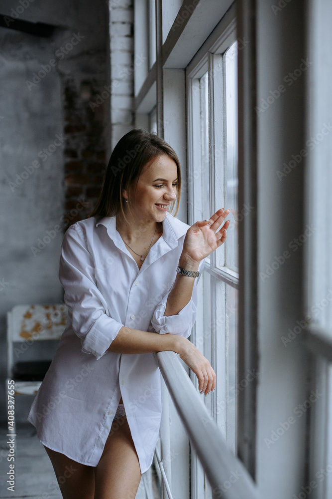 woman standing in front of window