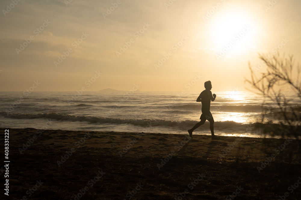 silhouette man run on beach with sunrise and sea background