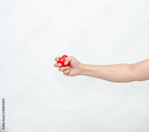 Hand holding heart grip tight on white background.