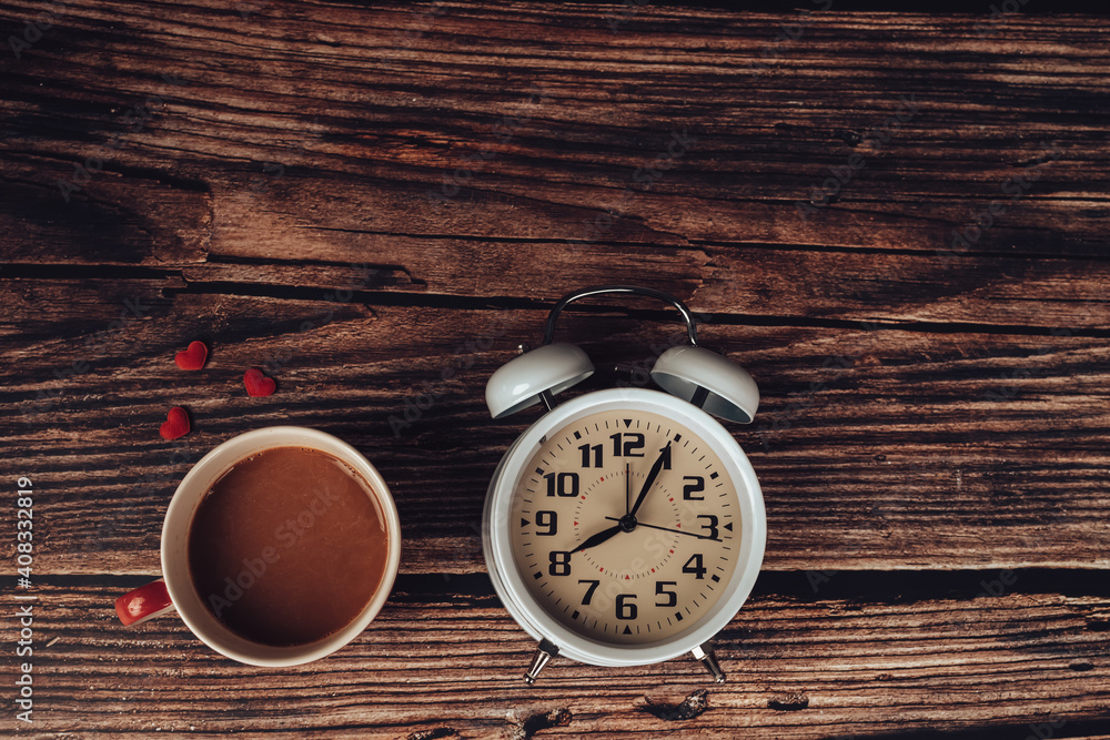 Alarm clock, heart shape and coffee on wood table. Alarm clock, heart shape and coffee on wood table.