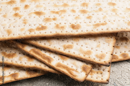 Jewish flatbread matza for Passover on table, closeup photo