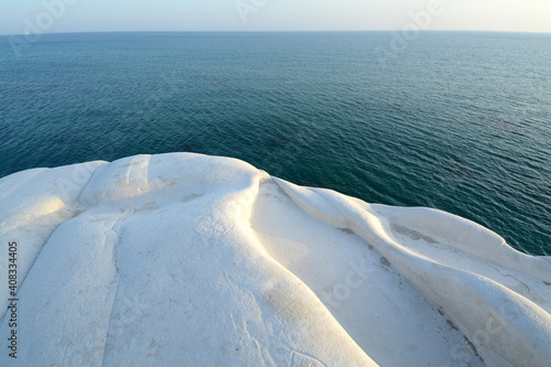 The Scala dei Turchi is a pure white rock wall that rises steeply into the Mediterranean Sea along the coast of Realmonte in Agrigento. photo