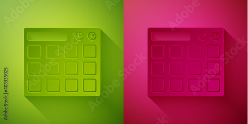 Paper cut Drum machine music producer equipment icon isolated on green and pink background. Paper art style. Vector.