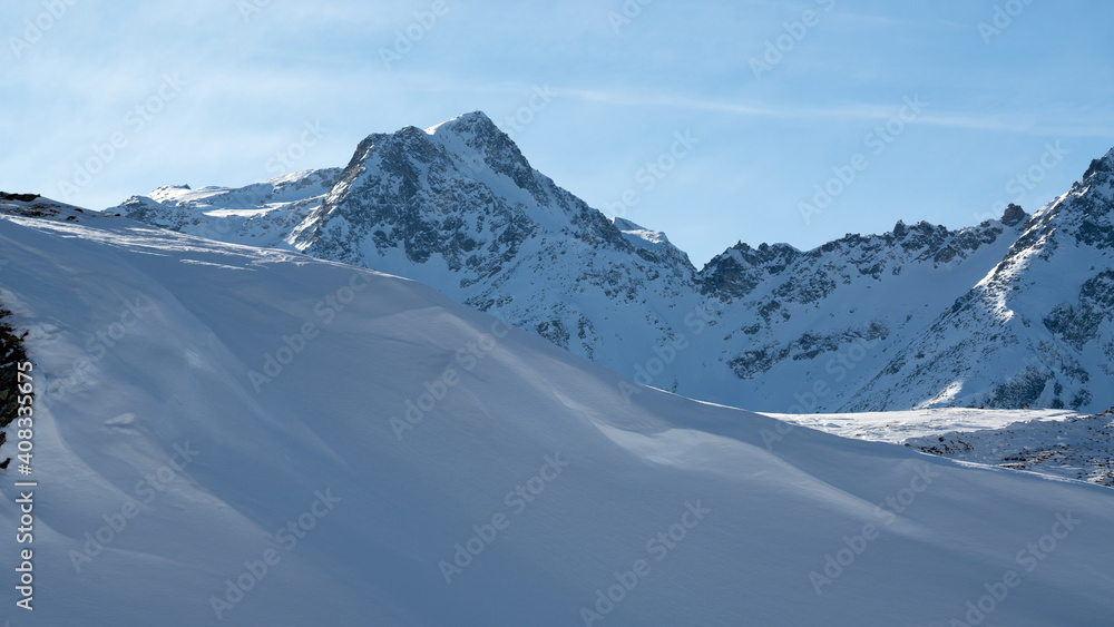 beautiful alpine landscape with fresh snow on a sunny day