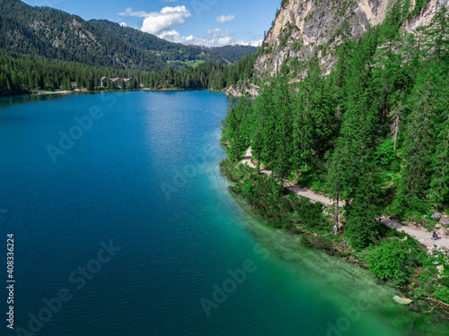 Aerial view of the Lake Braies, Pragser Wildsee is a lake in the Prags Dolomites in South Tyrol, Italy. People walking and trekking along the paths that run along the lake