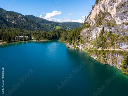 Aerial view of the Lake Braies, Pragser Wildsee is a lake in the Prags Dolomites in South Tyrol, Italy. People walking and trekking along the paths that run along the lake