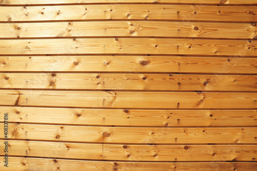 Spruce, pine, fir wood siding good for exterior walls and sauna interiors. A pine fir wood siding, knotty pine clapboard paneling and siding background with a copy space.