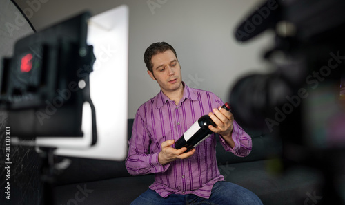 Man making video blog about wine and alcohol.