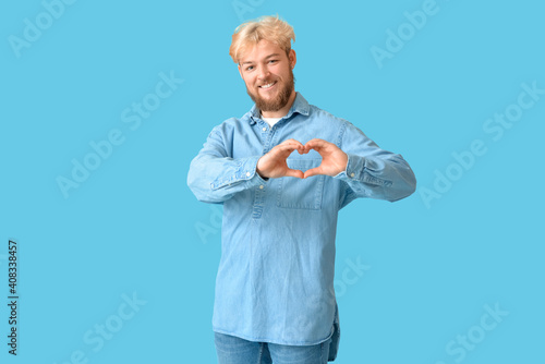 Handsome man making heart w...