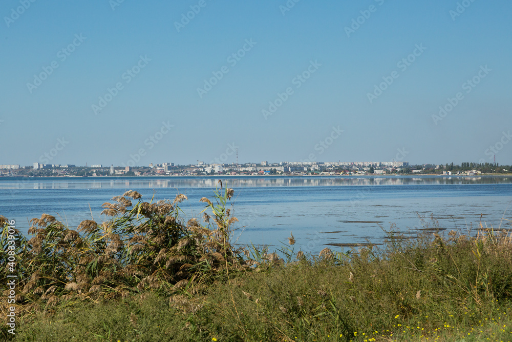 City landscape across the bay with water reflection.
City landscape across the bay with water reflection.