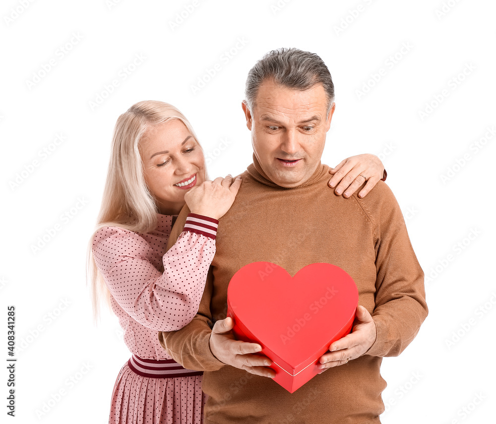 Mature couple with gift on white background. Valentine's Day celebration Mature couple with gift on white background. Valentine's Day celebration