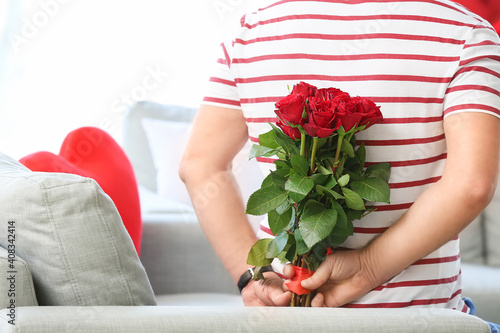 Fototapeta Naklejka Na Ścianę i Meble -  Mature man with bouquet of flowers for his wife at home on Valentine's Day