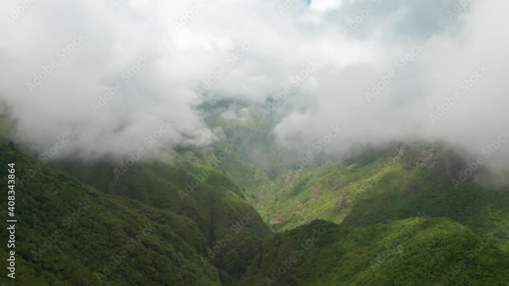 Epic scenery of dreamy clouds above shaded green valley in Madeira mountains Epic scenery of dreamy clouds above shaded green valley in Madeira mountains