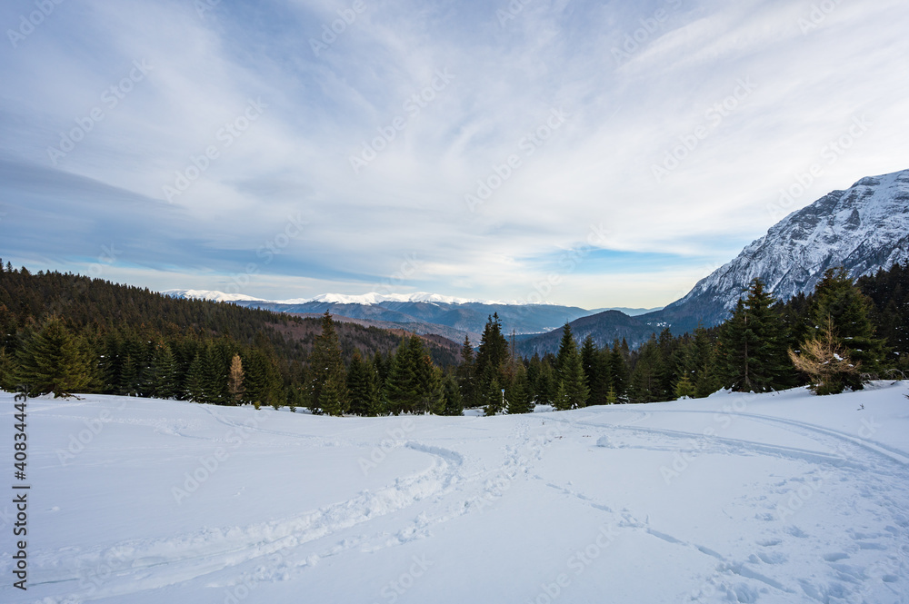 View from Bucegi mountains over Prahova valley in winter with snow covered Carpathian mountains