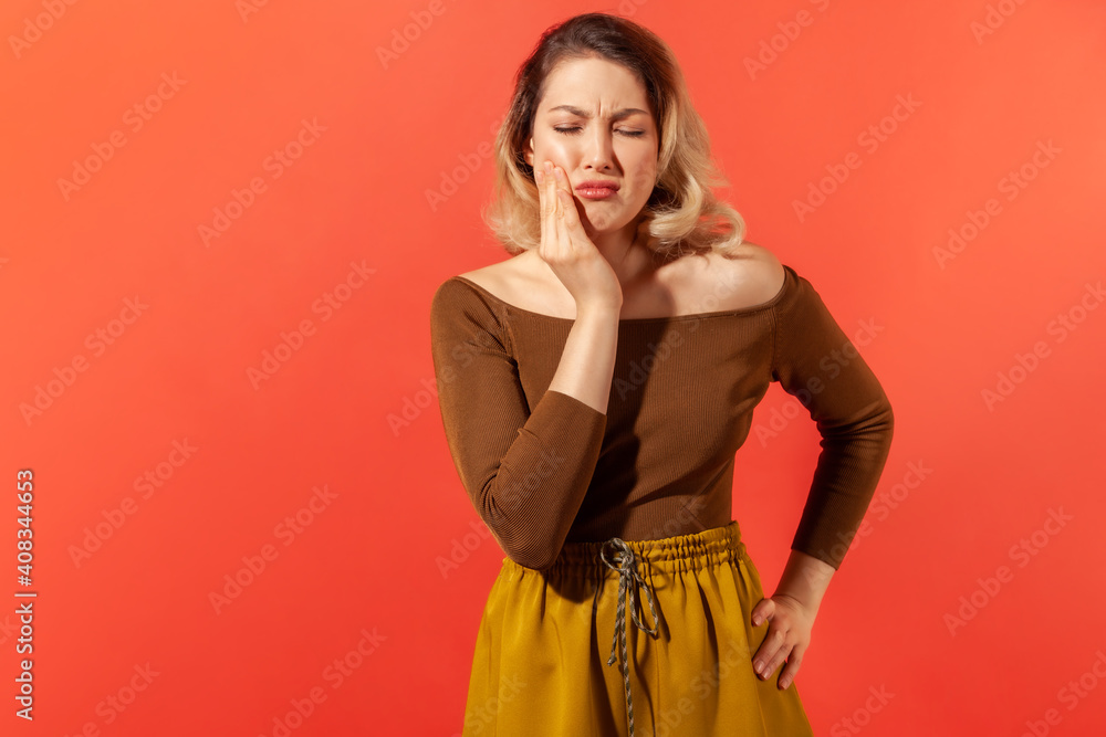 Blonde girl touching cheek and feeling toothache Blonde girl touching cheek and feeling toothache
