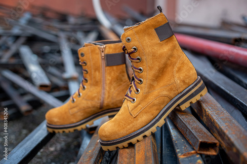 Yellowish brown genuine cow leather desert boots style on street background. Pictures suitable for shoe stores.Or websites that tell stories about different types of shoes.Fashion trend.