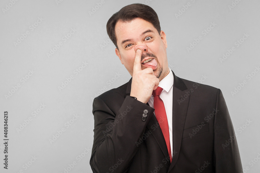 Crazy stupid businessman picking one's nose Crazy stupid businessman picking one's nose
