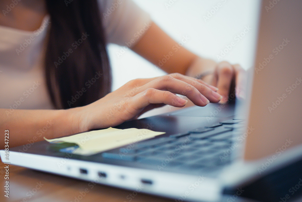 Fototapeta premium Close up hand of business people, student, adult typing text, email and searching information while sitting at home, workplace. Working on laptop computer concept.