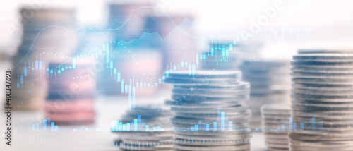 Double exposure Candle stick graph chart with indicator image of coin stacks on technology financial graph background. Finance and investment concept. Selective focus.