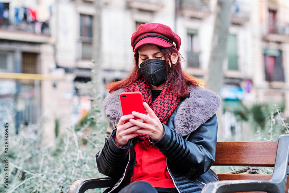 Woman with face mask and using phone outdoors. Woman with face mask and using phone outdoors.