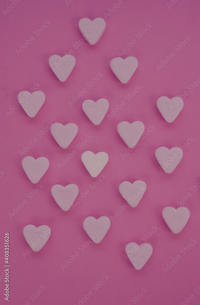 colored sweet hearts for valentine pink red background